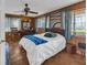 Cozy bedroom with wood paneled walls, a large window, and a comfortable bed at 1103 Palma Sola Blvd, Bradenton, FL 34209