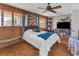 Bedroom with wood paneled walls, a large window, and a comfortable bed at 1103 Palma Sola Blvd, Bradenton, FL 34209