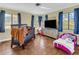 Bright bedroom with large windows, hardwood floors, and room for a crib and toddler bed at 1103 Palma Sola Blvd, Bradenton, FL 34209