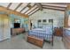 Bedroom with vaulted ceilings, bamboo wallpaper, wood dresser, and carpeted floors at 1103 Palma Sola Blvd, Bradenton, FL 34209
