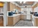 Traditional kitchen boasts ample cabinet space, white appliances, and a view into an adjacent living area at 1103 Palma Sola Blvd, Bradenton, FL 34209