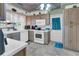 Well-lit kitchen with ample counter space and a separate door leading to the outside, plus gray and white color scheme at 1103 Palma Sola Blvd, Bradenton, FL 34209