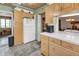 Functional kitchen features a white refrigerator and tile countertop, with access to the dining and living area at 1103 Palma Sola Blvd, Bradenton, FL 34209
