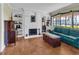 Inviting living room featuring a white brick fireplace and built-in shelving, complemented by a hardwood floor at 1103 Palma Sola Blvd, Bradenton, FL 34209