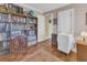 Office space features hardwood floors, a bookshelf, and an adjacent room visible through the doorway at 1103 Palma Sola Blvd, Bradenton, FL 34209