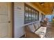 Inviting porch with wicker seating, offering a comfortable outdoor space with a view of the neighborhood at 1103 Palma Sola Blvd, Bradenton, FL 34209
