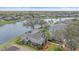 Waterfront home featuring a screened lanai with a pool, landscaping, and direct access to the serene canal at 11910 Soft Rush Ter, Lakewood Ranch, FL 34202