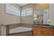 Bright bathroom featuring a soaking tub, shuttered windows, and modern vanity with a large mirror at 11910 Soft Rush Ter, Lakewood Ranch, FL 34202