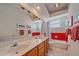 Bright bathroom featuring a double sink vanity, red accents, and ample natural light at 11910 Soft Rush Ter, Lakewood Ranch, FL 34202