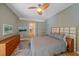 Bedroom with en-suite bathroom access and a view of nature at 11910 Soft Rush Ter, Lakewood Ranch, FL 34202