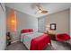 Cozy bedroom with a ceiling fan, shuttered window, and red accents adding a pop of color at 11910 Soft Rush Ter, Lakewood Ranch, FL 34202