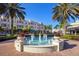 Community fountain surrounded by commercial buildings, palm trees, and benches at 11910 Soft Rush Ter, Lakewood Ranch, FL 34202