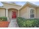 Charming front entry with a red door and well-manicured landscaping at 11910 Soft Rush Ter, Lakewood Ranch, FL 34202