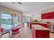 Open kitchen flows to breakfast area with a view of the pool and a large window at 11910 Soft Rush Ter, Lakewood Ranch, FL 34202