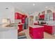 Modern kitchen with sleek red cabinets, stainless steel appliances, and granite countertops at 11910 Soft Rush Ter, Lakewood Ranch, FL 34202