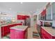 Stylish kitchen with a center island, stainless steel appliances, and vibrant red cabinetry at 11910 Soft Rush Ter, Lakewood Ranch, FL 34202