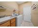 Bright laundry room featuring wood cabinets, sink, washer, and dryer at 11910 Soft Rush Ter, Lakewood Ranch, FL 34202