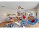 Bright living room featuring colorful rug, ceiling fan, and open view of the kitchen at 11910 Soft Rush Ter, Lakewood Ranch, FL 34202
