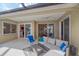 Relaxing covered patio area with comfortable seating and sliding glass doors at 11910 Soft Rush Ter, Lakewood Ranch, FL 34202