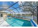 Screened-in pool area offering tranquil water views and a serene ambiance at 11910 Soft Rush Ter, Lakewood Ranch, FL 34202
