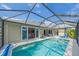 Screened pool with views of the water and outdoor seating at 11910 Soft Rush Ter, Lakewood Ranch, FL 34202