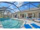 Beautiful screened-in pool with outdoor seating and water view at 11910 Soft Rush Ter, Lakewood Ranch, FL 34202