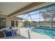 Screened pool overlooking tranquil waterfront, with seating at 11910 Soft Rush Ter, Lakewood Ranch, FL 34202