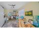 Bright home studio space with painting supplies, ample natural light, and a ceiling fan at 11910 Soft Rush Ter, Lakewood Ranch, FL 34202