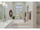 Elegant bathroom with a soaking tub, a separate shower, and dual sinks with stone countertops at 121 N Boulevard Of Presidents, Sarasota, FL 34236