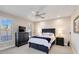 Bedroom with a queen bed, matching nightstands, dresser, ceiling fan and two shuttered windows at 121 N Boulevard Of Presidents, Sarasota, FL 34236