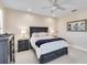 Bedroom with a queen bed, matching nightstands, dresser, ceiling fan and two shuttered windows at 121 N Boulevard Of Presidents, Sarasota, FL 34236
