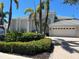 Beautiful home featuring a lush landscaped front yard, charming architectural details, and a spacious two-car garage at 121 N Boulevard Of Presidents, Sarasota, FL 34236