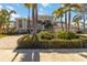 Beautiful home featuring lush landscaping, a charming entryway, and a grand three-car garage at 121 N Boulevard Of Presidents, Sarasota, FL 34236