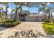 Stunning luxury home boasting meticulous landscaping, a paved driveway, and an attached three-car garage at 121 N Boulevard Of Presidents, Sarasota, FL 34236