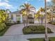 Elegant home showcasing manicured landscaping, a classic entryway, and a convenient three-car garage at 121 N Boulevard Of Presidents, Sarasota, FL 34236