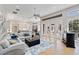 Open concept living area with comfortable seating, stylish rug, and bright view through french doors at 121 N Boulevard Of Presidents, Sarasota, FL 34236