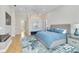 Serene main bedroom with high ceilings, ceiling fan, stylish decor, and hardwood floors at 121 N Boulevard Of Presidents, Sarasota, FL 34236