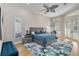 Bright main bedroom featuring a tray ceiling, neutral decor, ceiling fan and hardwood floors at 121 N Boulevard Of Presidents, Sarasota, FL 34236