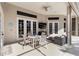 An outdoor patio with a dining table, chairs, and couch under a ceiling fan at 121 N Boulevard Of Presidents, Sarasota, FL 34236