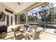 Outdoor living space with a dining table, chairs, and view of the pool at 121 N Boulevard Of Presidents, Sarasota, FL 34236