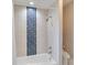 Bright bathroom featuring a shower-tub combination with white and blue subway tile at 121 N Boulevard Of Presidents, Sarasota, FL 34236