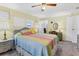 Comfortable bedroom featuring a ceiling fan, natural light, and cozy decor at 1210 44Th Avenue E Dr, Ellenton, FL 34222