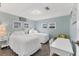 Bright bedroom featuring two twin beds with white linens, light blue walls and natural light at 1210 44Th Avenue E Dr, Ellenton, FL 34222