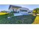 Cozy single-story home with a covered porch, green lawn, and a cactus garden, offering a relaxed outdoor living space at 1210 44Th Avenue E Dr, Ellenton, FL 34222