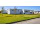 Exterior view of the house with well-maintained lawn and landscaping at 1210 44Th Avenue E Dr, Ellenton, FL 34222