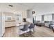 Bright kitchen with white cabinetry, stylish countertops, and seating area, open to living room at 1210 44Th Avenue E Dr, Ellenton, FL 34222