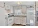 Cozy kitchen featuring white appliances, ample cabinetry, and a window view at 1210 44Th Avenue E Dr, Ellenton, FL 34222