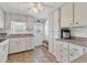 Well-lit kitchen with ample white cabinets, granite countertops, and modern appliances at 1210 44Th Avenue E Dr, Ellenton, FL 34222