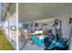 Covered patio with golf cart parked, offering shaded space and convenience at 1210 44Th Avenue E Dr, Ellenton, FL 34222