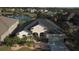 Aerial view of home showcasing lush landscaping and a tranquil pond in a peaceful community at 12286 23Rd E St, Parrish, FL 34219